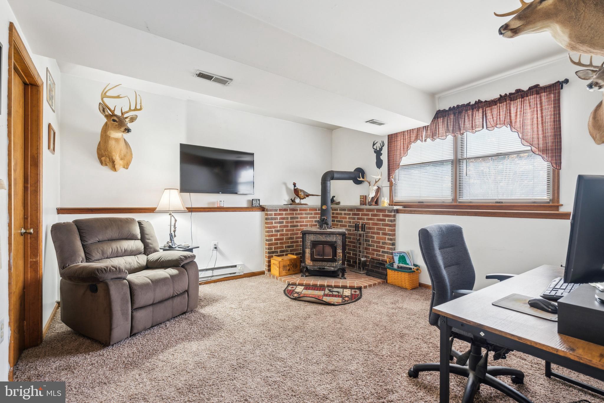 20 Holly Trail Alloway, NJ 08302 - Photo 18 of 26 a living room with furniture a flat screen tv and a window