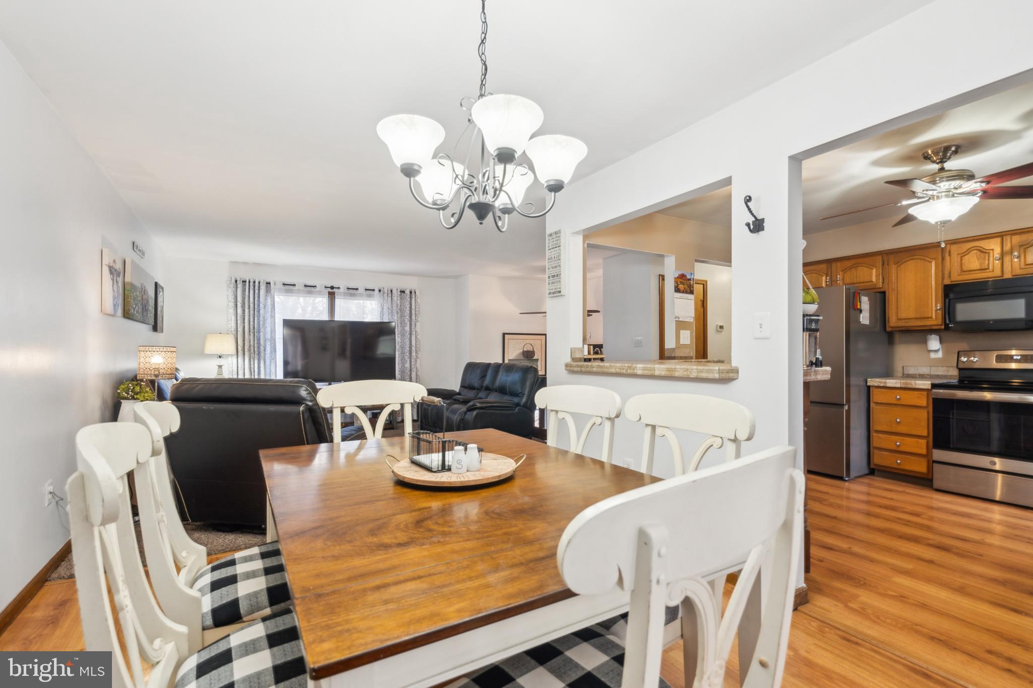 20 Holly Trail Alloway, NJ 08302 - Photo 8 of 26 a view of a dining room with furniture a chandelier and wooden floor
