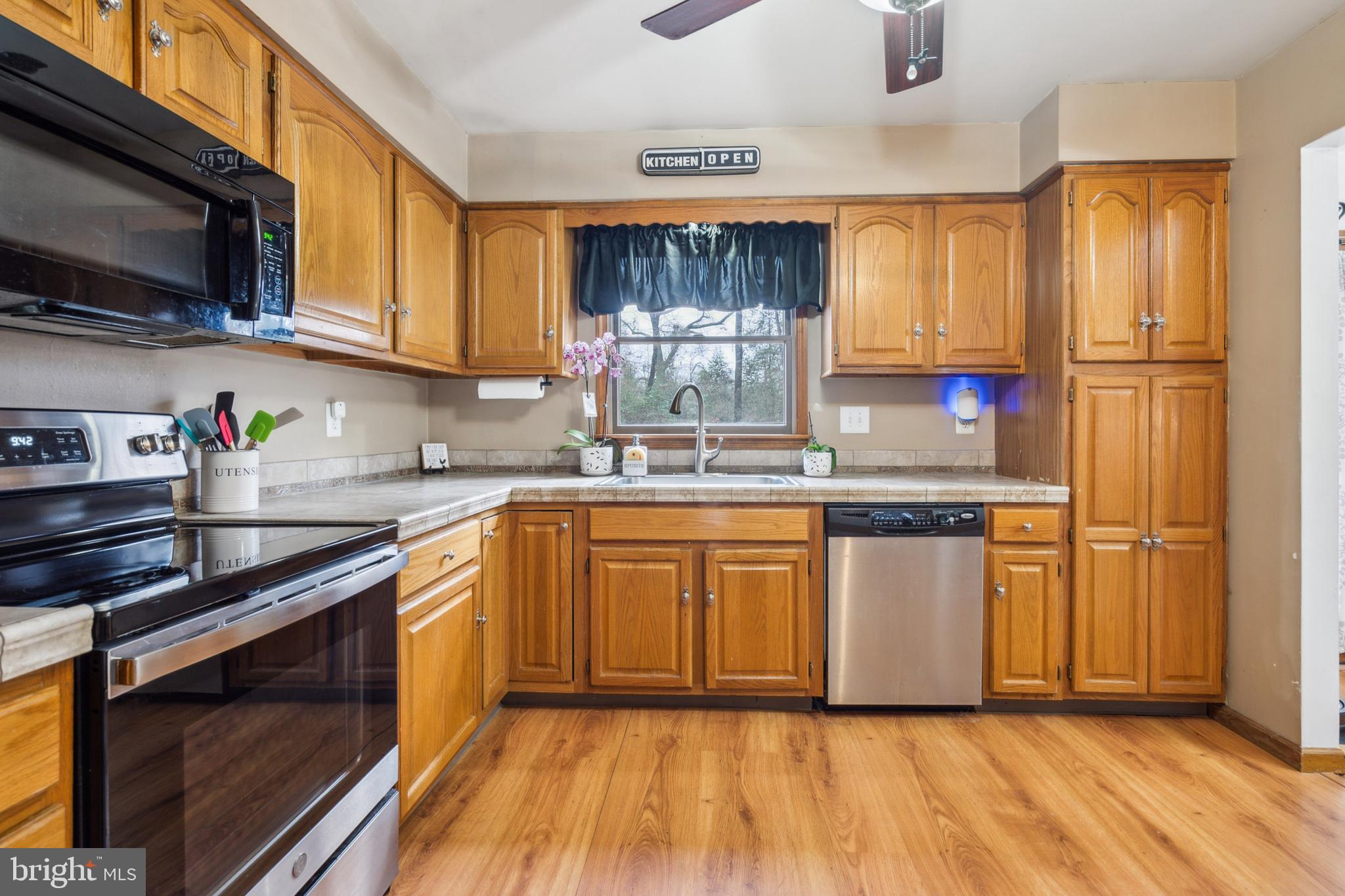 20 Holly Trail Alloway, NJ 08302 - Photo 10 of 26 a kitchen with stainless steel appliances granite countertop a refrigerator a sink dishwasher a stove top oven a refrigerator with wooden floor and cabinets