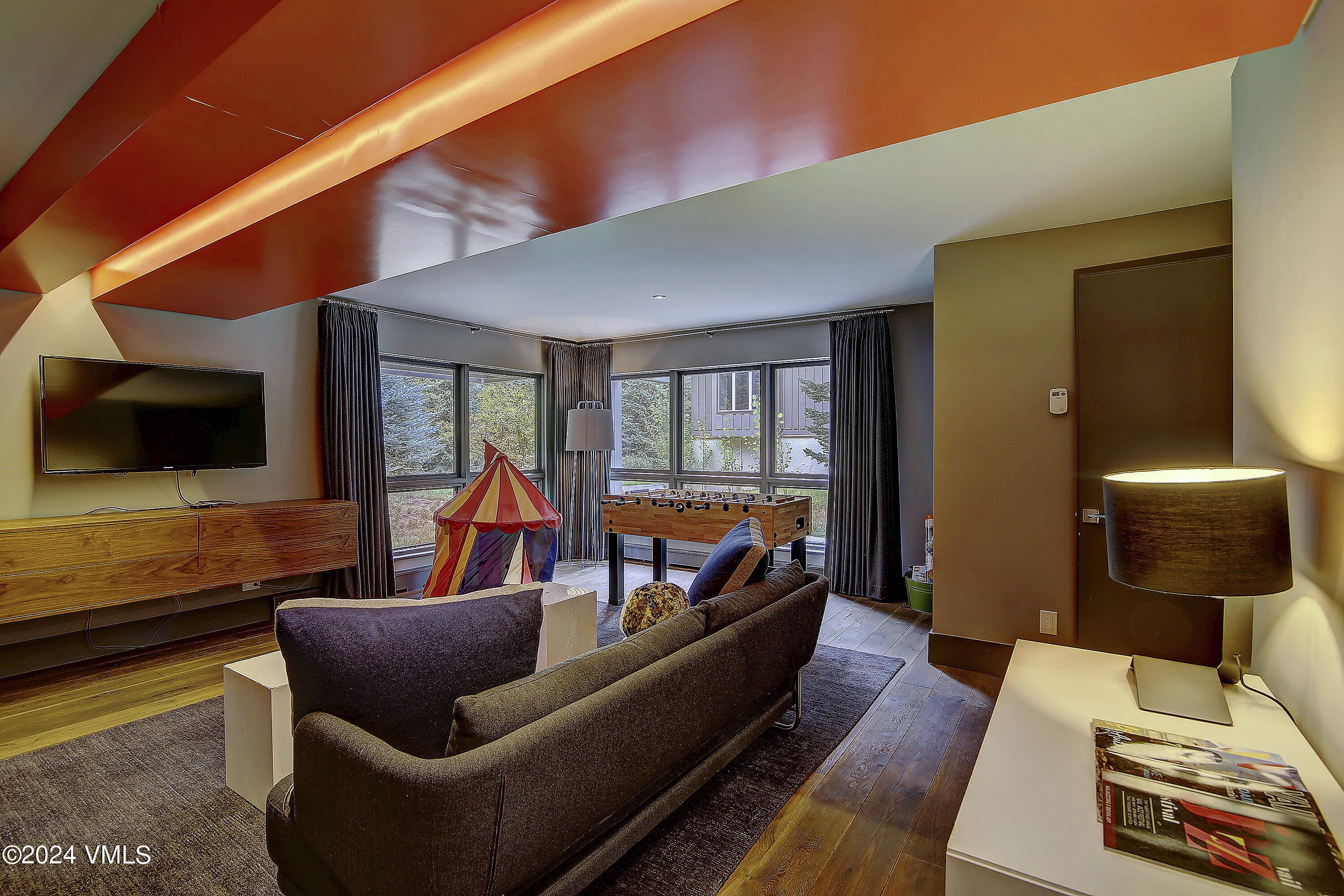 1042 Eagles Nest Circle Vail, CO 81657 - Photo 6 of 24 a living room with furniture and a flat screen tv