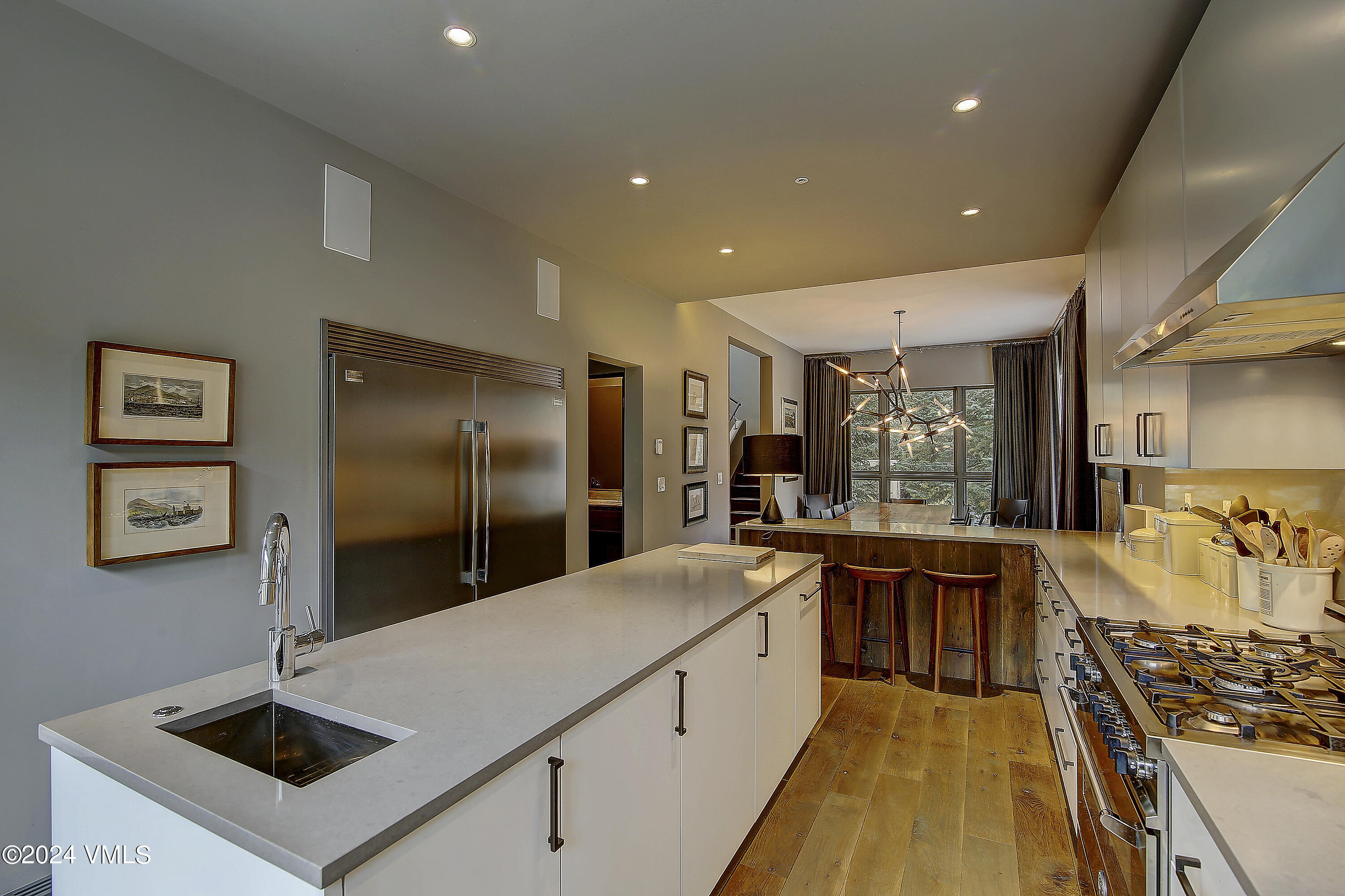1042 Eagles Nest Circle Vail, CO 81657 - Photo 8 of 24 a large kitchen with stainless steel appliances a large counter top a stove and a refrigerator