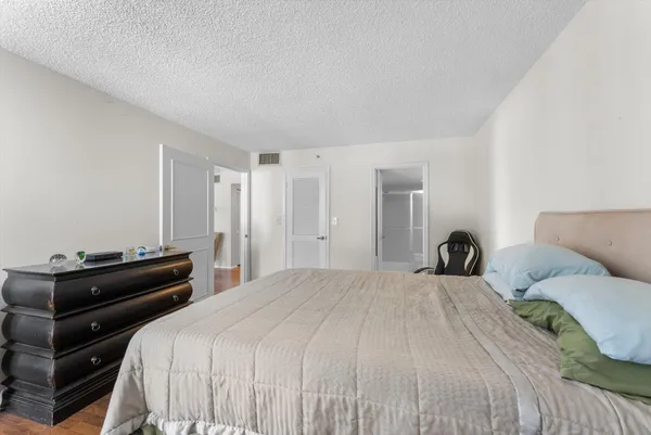 a bedroom with a bed and a dresser