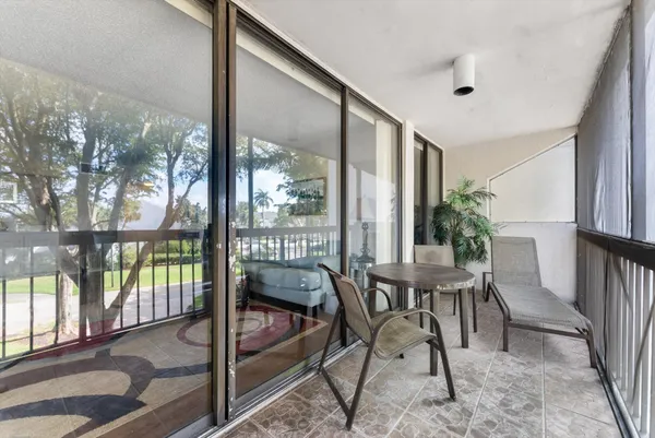 a view of a porch with chairs and backyard