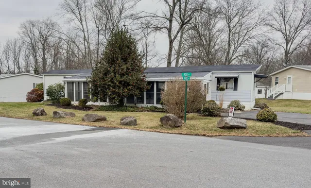 a house that has a tree in front of it