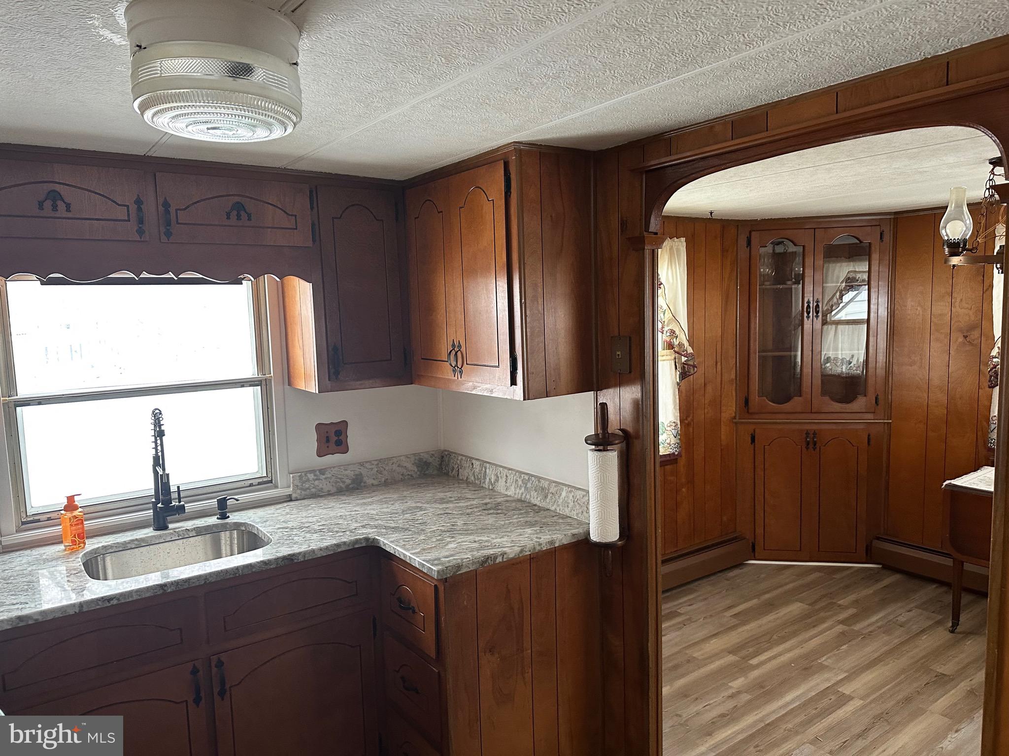 9 Maple Quakertown, PA 18951 - Photo 6 of 12 a kitchen with a sink and wooden cabinets