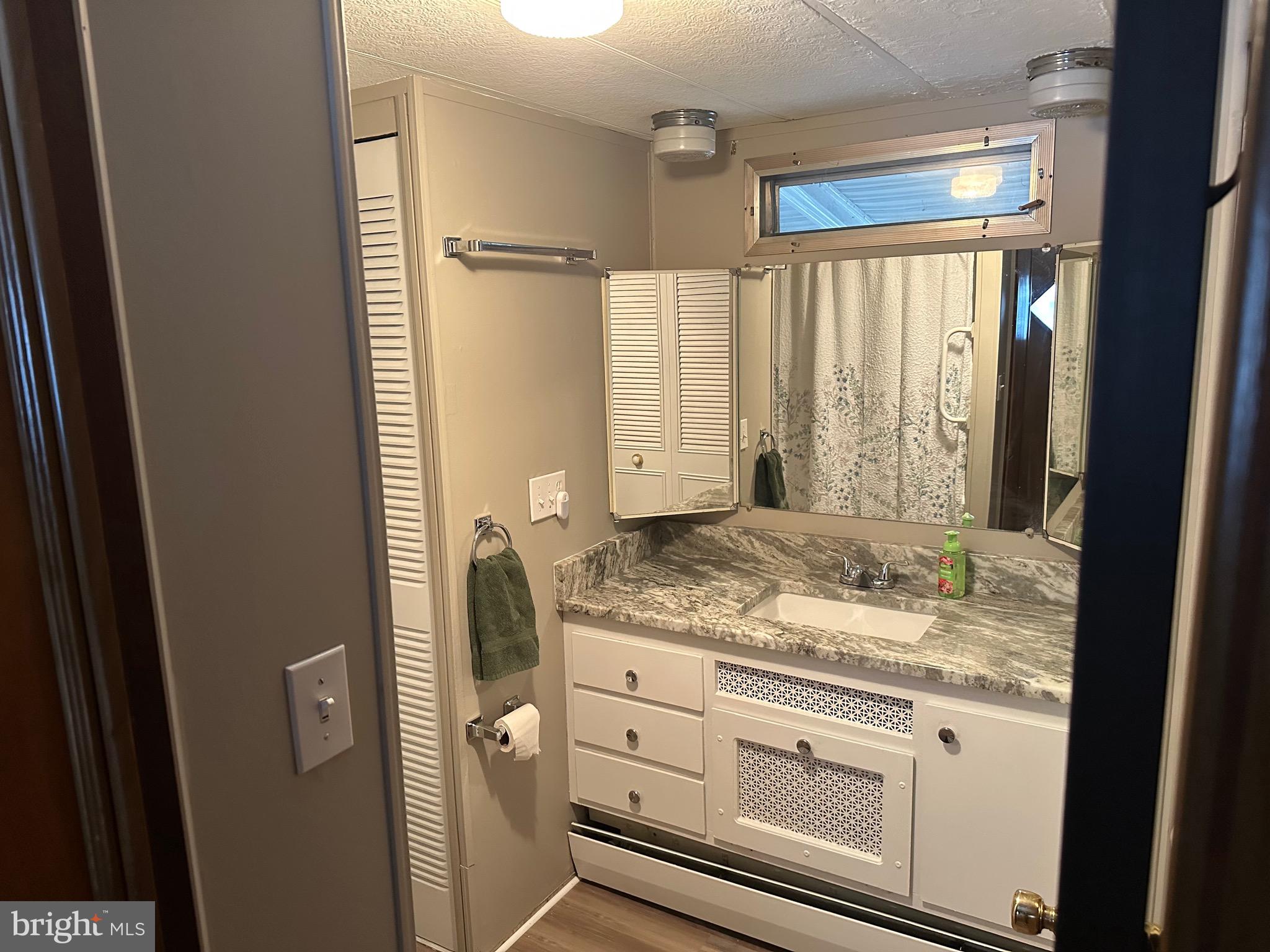 9 Maple Quakertown, PA 18951 - Photo 8 of 12 a bathroom with a granite countertop sink and a mirror