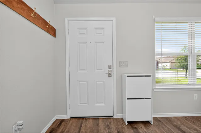 a view of walk in closet with hardwood floor