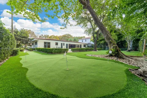 a view of a house with a backyard