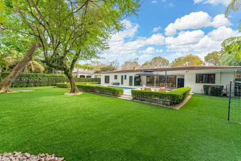 a view of a house with a yard deck and sitting area