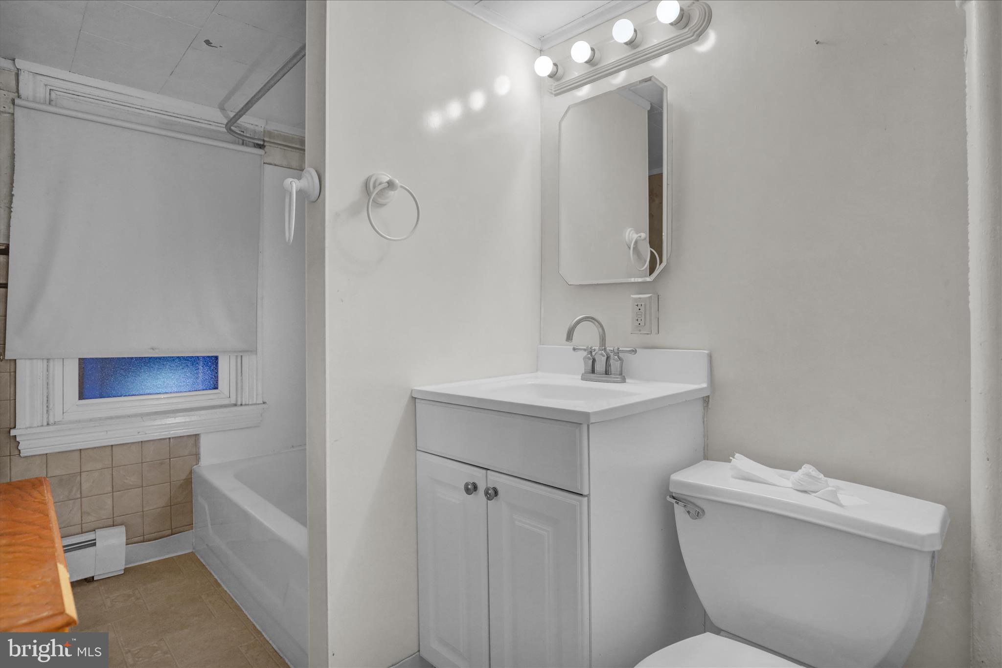 433 May Street Pottstown, PA 19464 - Photo 20 of 21 a bathroom with a sink mirror vanity and toilet