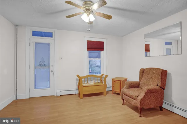 a living room with furniture and a ceiling fan