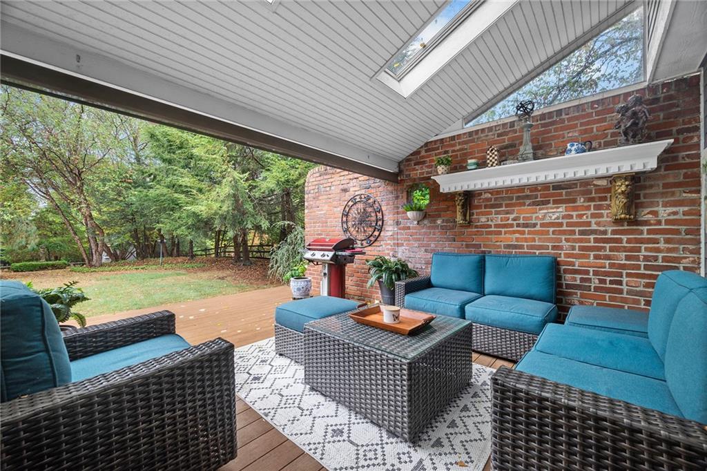 2779 Clearview Road Allison Park, PA 15101 - Photo 5 of 50 a view of a patio with couches chairs dining table and chairs barbeque grill with a small yard