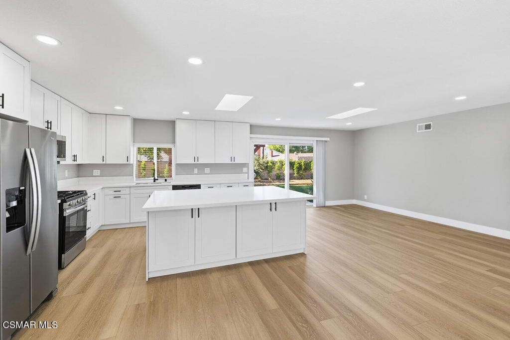 1069 Donner Avenue Simi Valley, CA 93065 - Photo 5 of 24 a kitchen with stainless steel appliances a refrigerator and a stove top oven