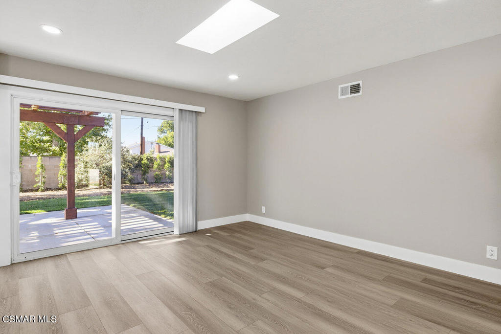 1069 Donner Avenue Simi Valley, CA 93065 - Photo 7 of 24 an empty room with wooden floor and windows