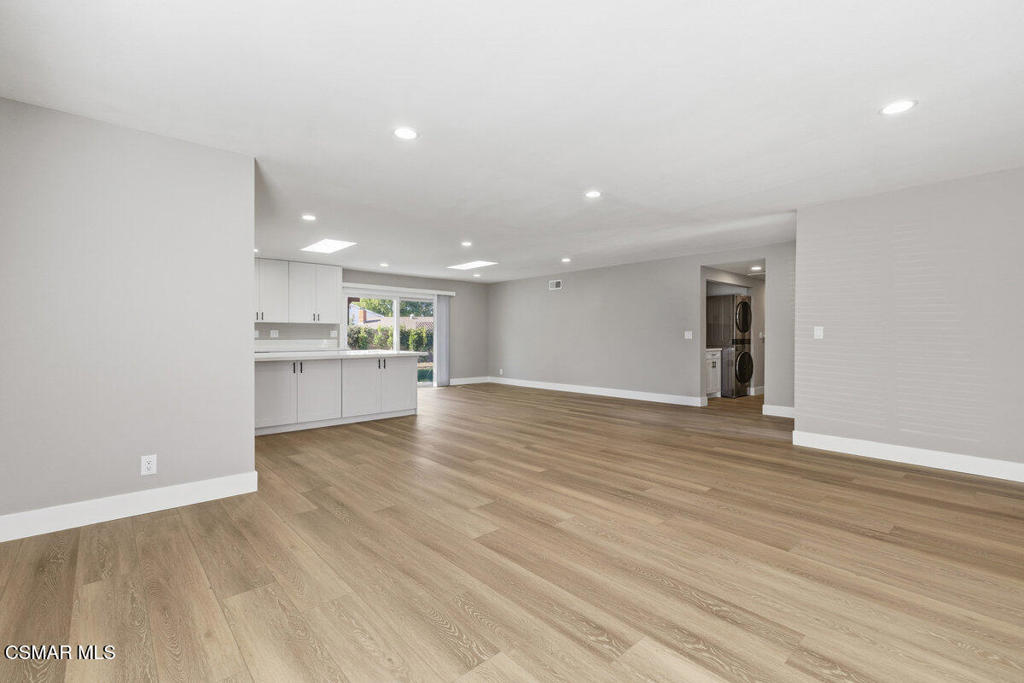 1069 Donner Avenue Simi Valley, CA 93065 - Photo 9 of 24 an empty room with wooden floor and kitchen view