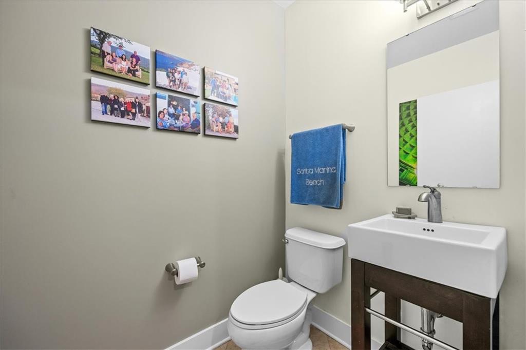 5811 Rippey Street, Unit B Pittsburgh, PA 15206 - Photo 14 of 25 a bathroom with a toilet a sink and a mirror
