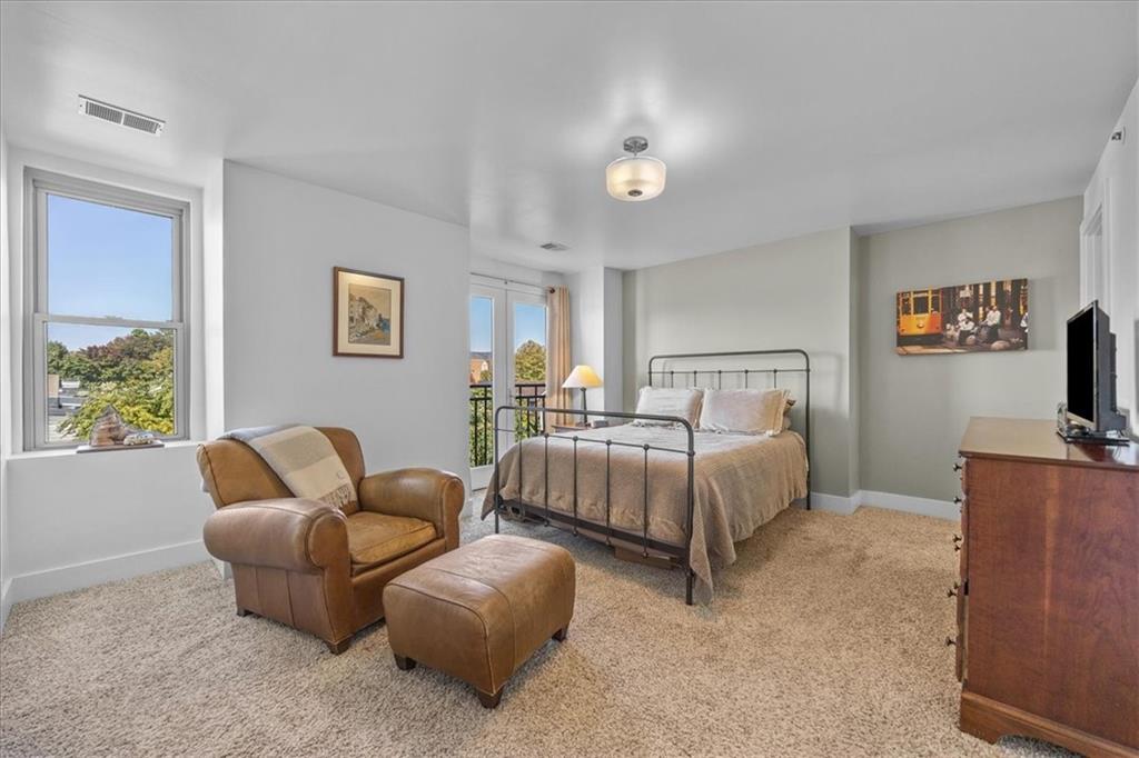 5811 Rippey Street, Unit B Pittsburgh, PA 15206 - Photo 15 of 25 a bedroom with bed and a couch