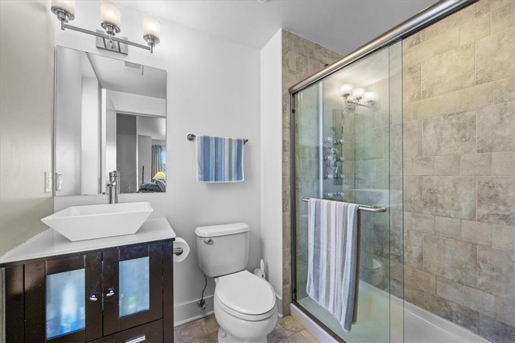 5811 Rippey Street, Unit B Pittsburgh, PA 15206 - Photo 16 of 25 a bathroom with a sink a toilet a mirror and shower