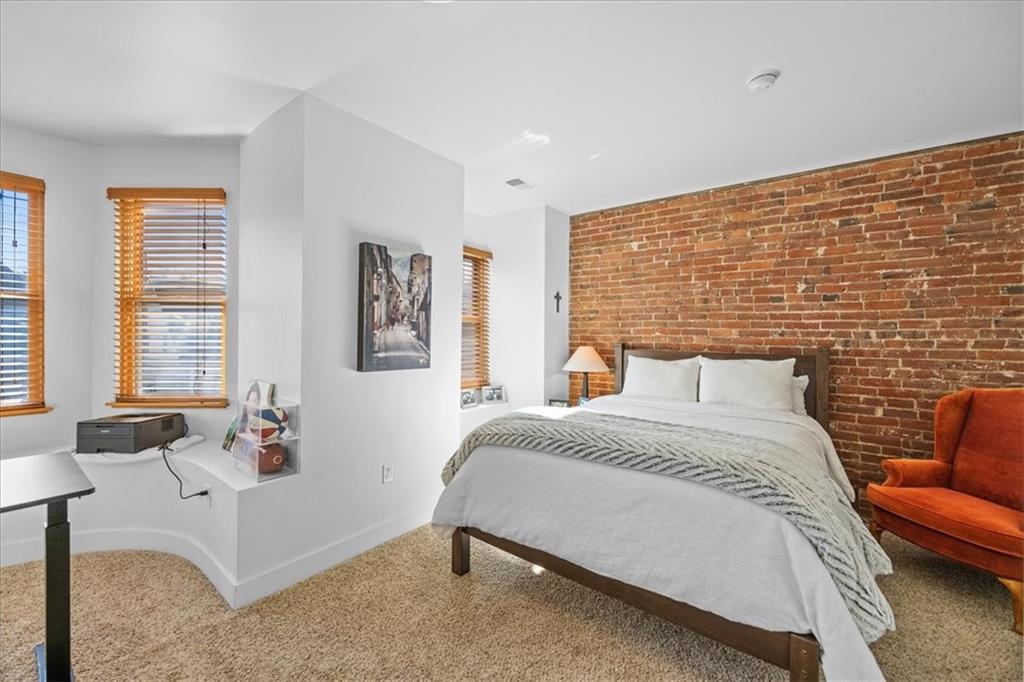 5811 Rippey Street, Unit B Pittsburgh, PA 15206 - Photo 17 of 25 a bedroom with a bed and a couch