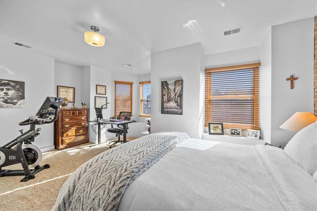 5811 Rippey Street, Unit B Pittsburgh, PA 15206 - Photo 18 of 25 a bed room with a bed and a chair