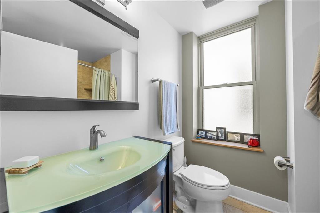 5811 Rippey Street, Unit B Pittsburgh, PA 15206 - Photo 21 of 25 a bathroom with a sink a toilet and a mirror