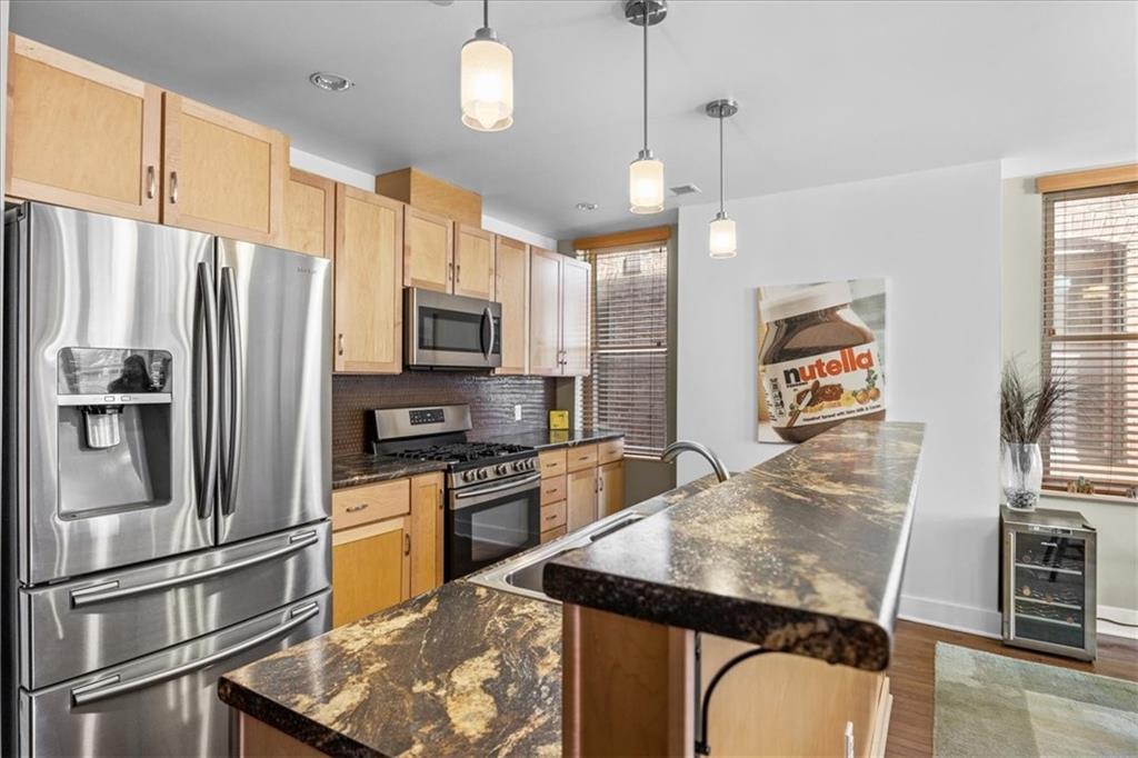 5811 Rippey Street, Unit B Pittsburgh, PA 15206 - Photo 4 of 25 a kitchen with stainless steel appliances granite countertop a refrigerator a stove top oven a sink and a refrigerator