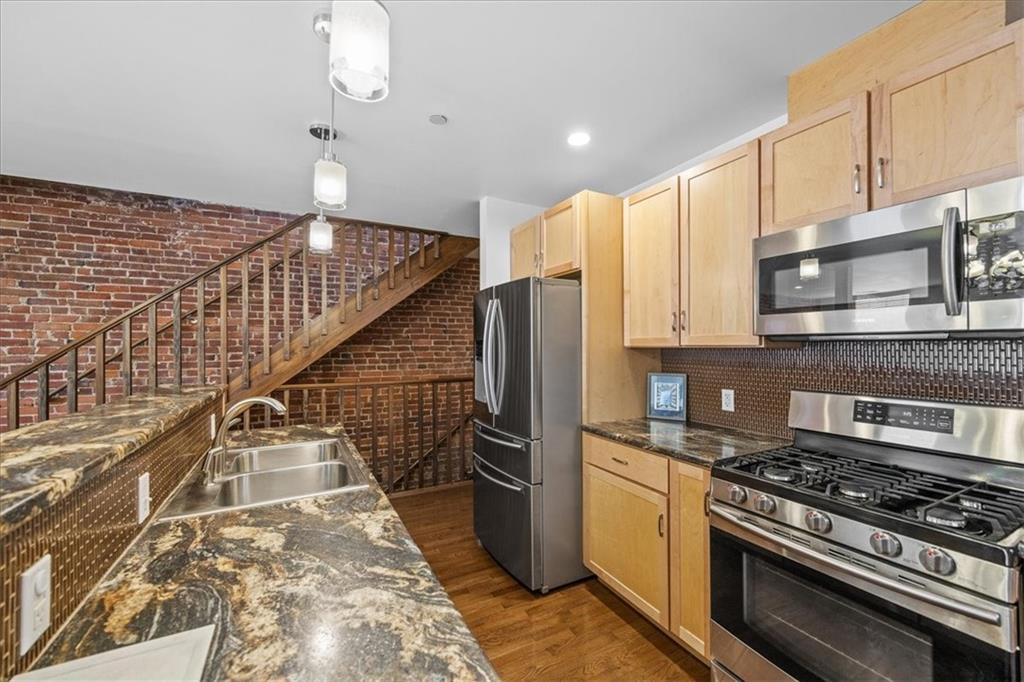 5811 Rippey Street, Unit B Pittsburgh, PA 15206 - Photo 5 of 25 a kitchen with granite countertop a stove and a refrigerator