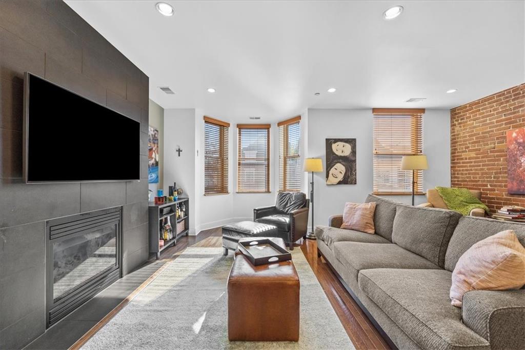 5811 Rippey Street, Unit B Pittsburgh, PA 15206 - Photo 9 of 25 a living room with furniture and a flat screen tv