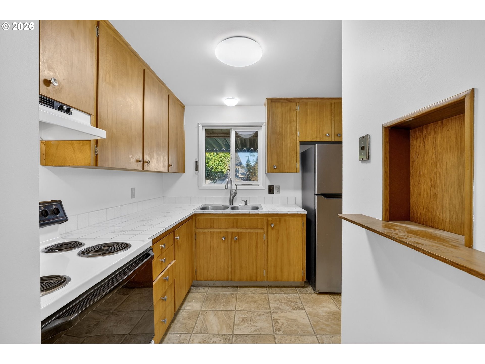 1620 Thompson Road Woodburn, OR 97071 - Photo 11 of 30 a kitchen with stainless steel appliances a stove a sink refrigerator and microwave