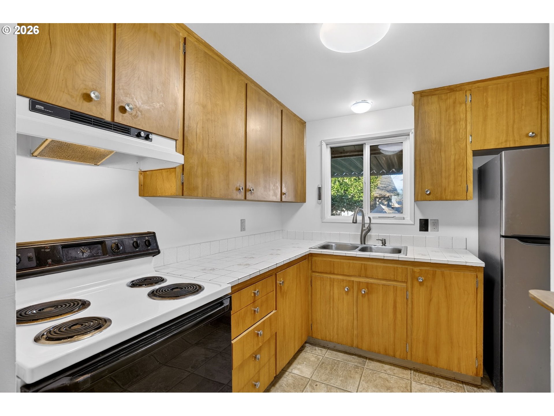 1620 Thompson Road Woodburn, OR 97071 - Photo 12 of 30 a kitchen with a sink a stove and refrigerator