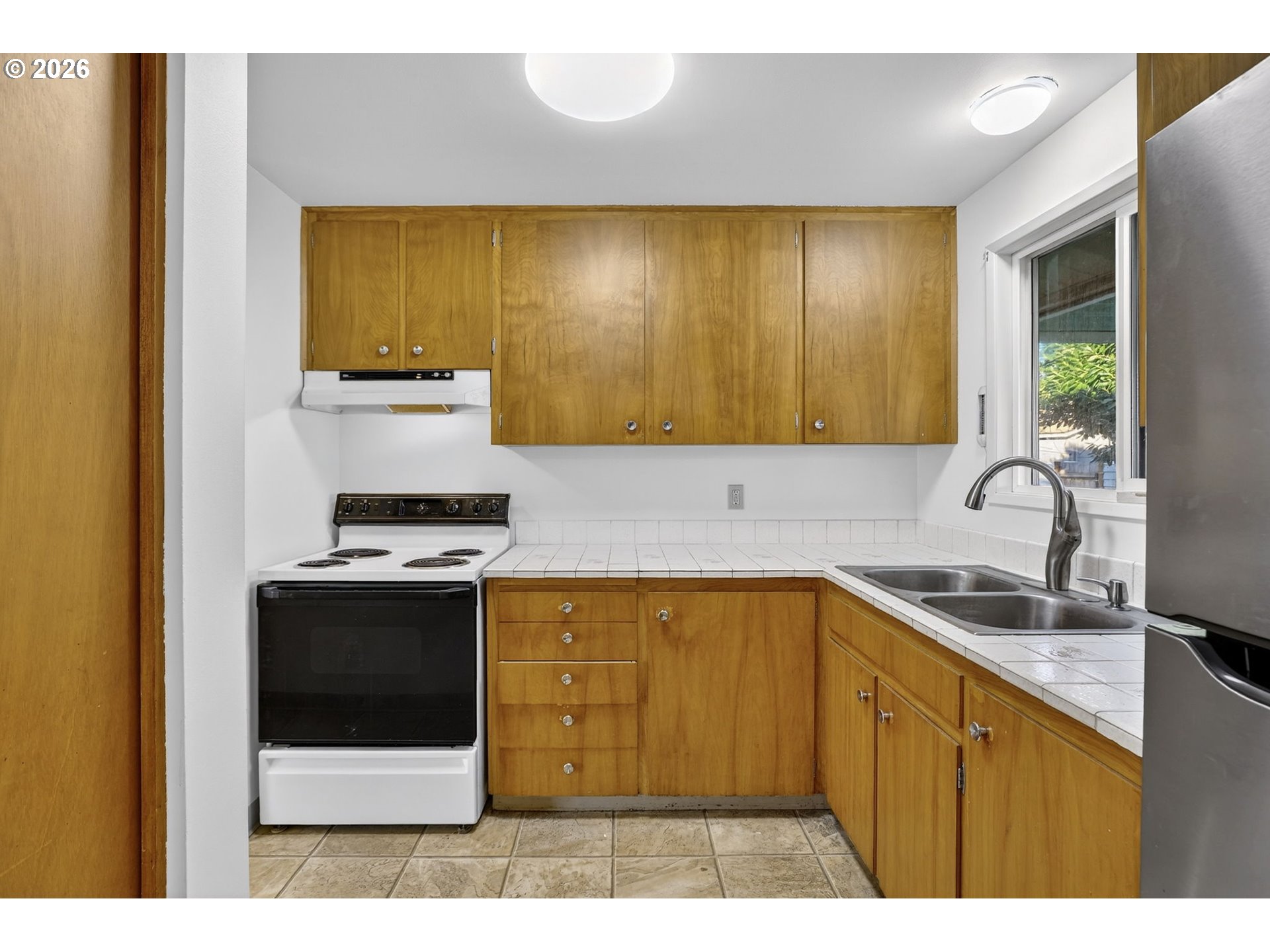 1620 Thompson Road Woodburn, OR 97071 - Photo 13 of 30 a kitchen with a sink and a stove with wooden floor