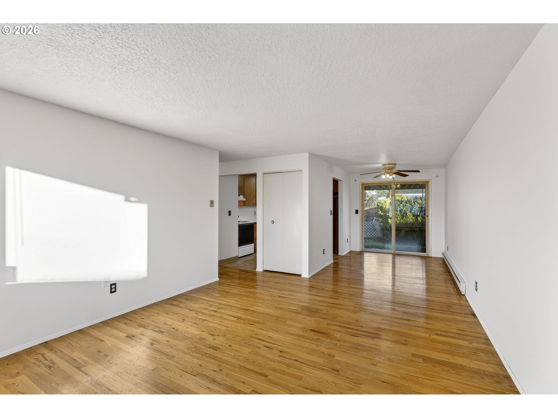 1620 Thompson Road Woodburn, OR 97071 - Photo 4 of 30 a view of an empty room with wooden floor and a window