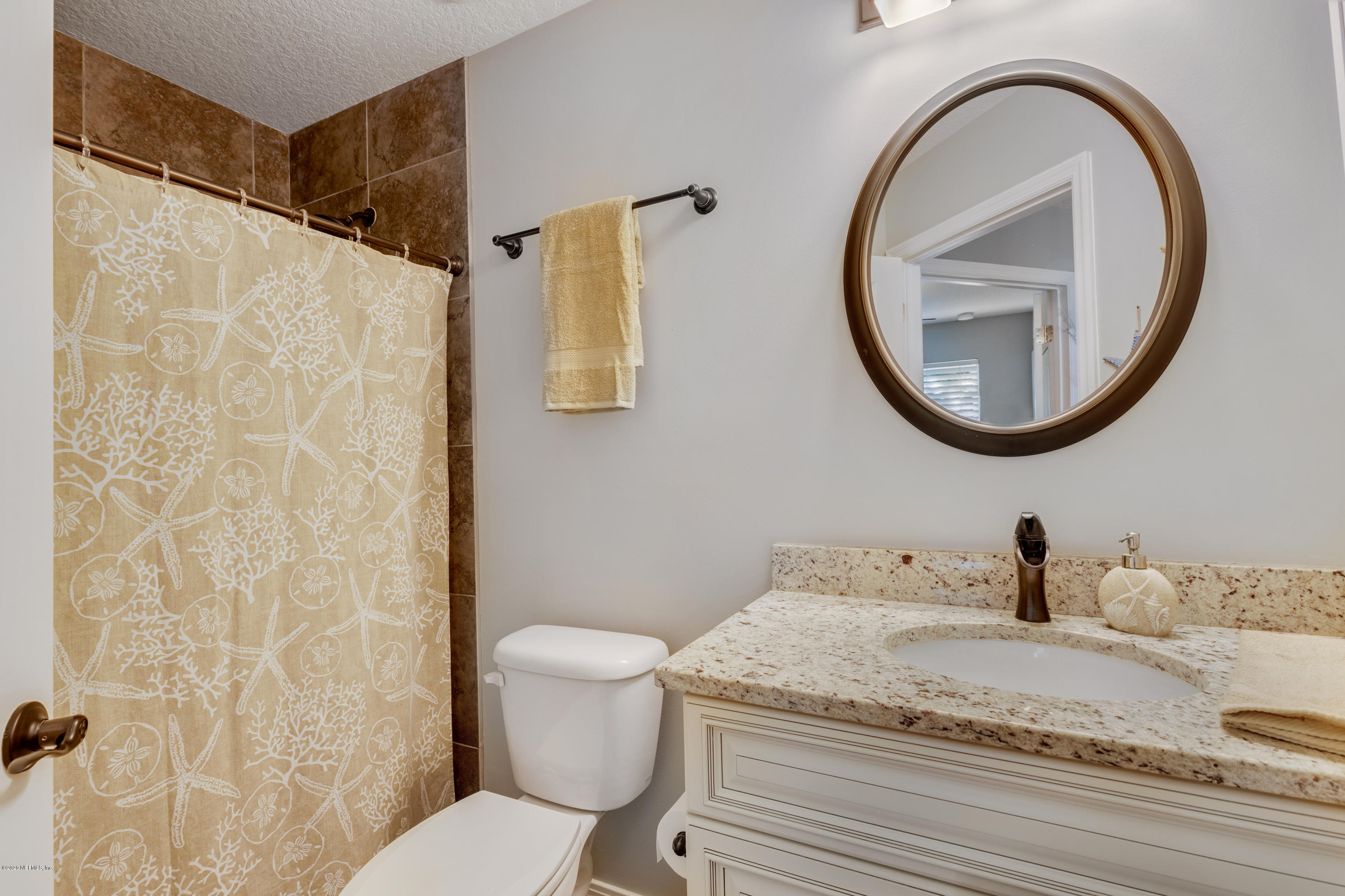 405 2nd Street St. Augustine, FL 32084 - Photo 16 of 32 a bathroom with a granite countertop sink and a mirror