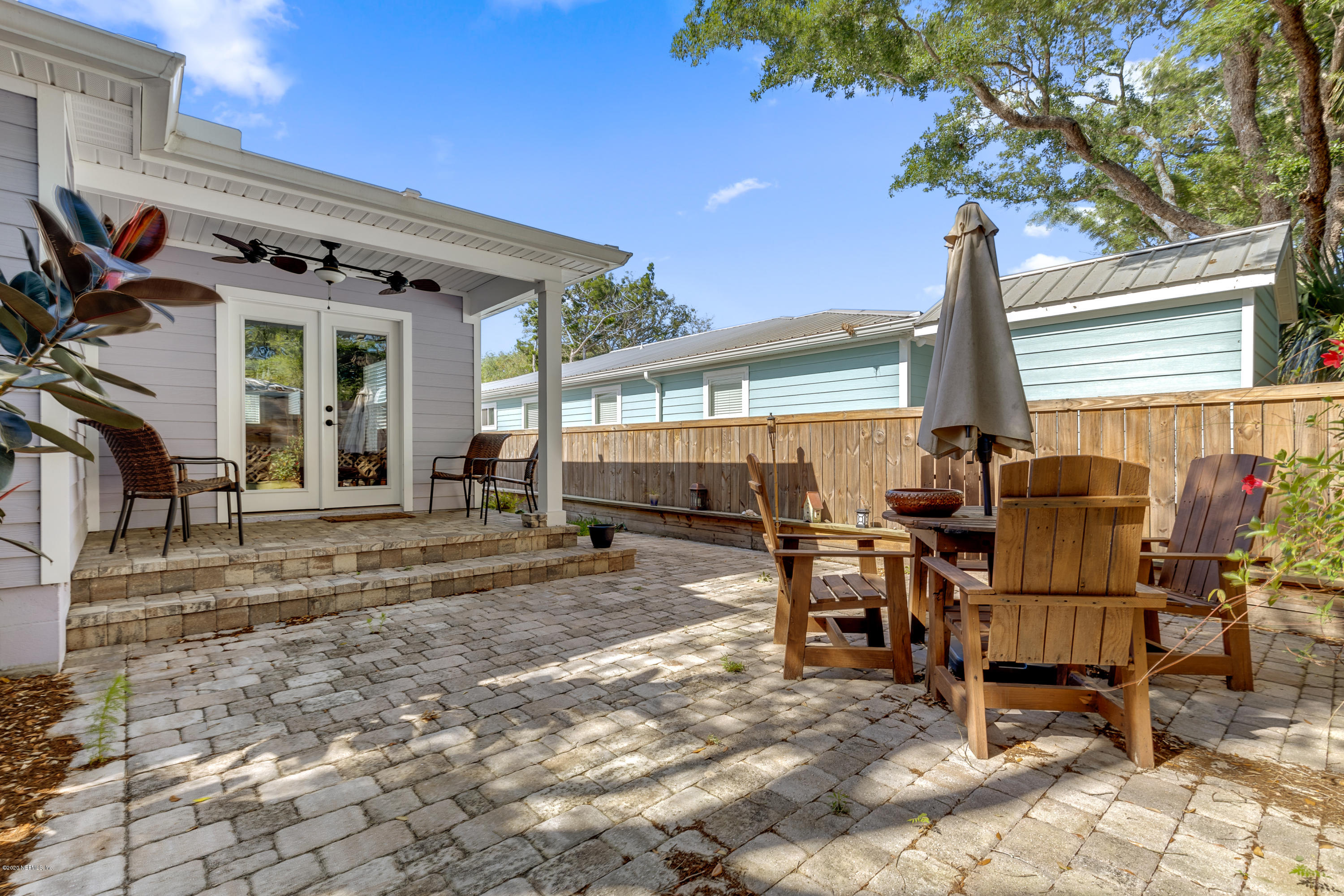 405 2nd Street St. Augustine, FL 32084 - Photo 24 of 32 a view of a dinning table and chairs in the patio