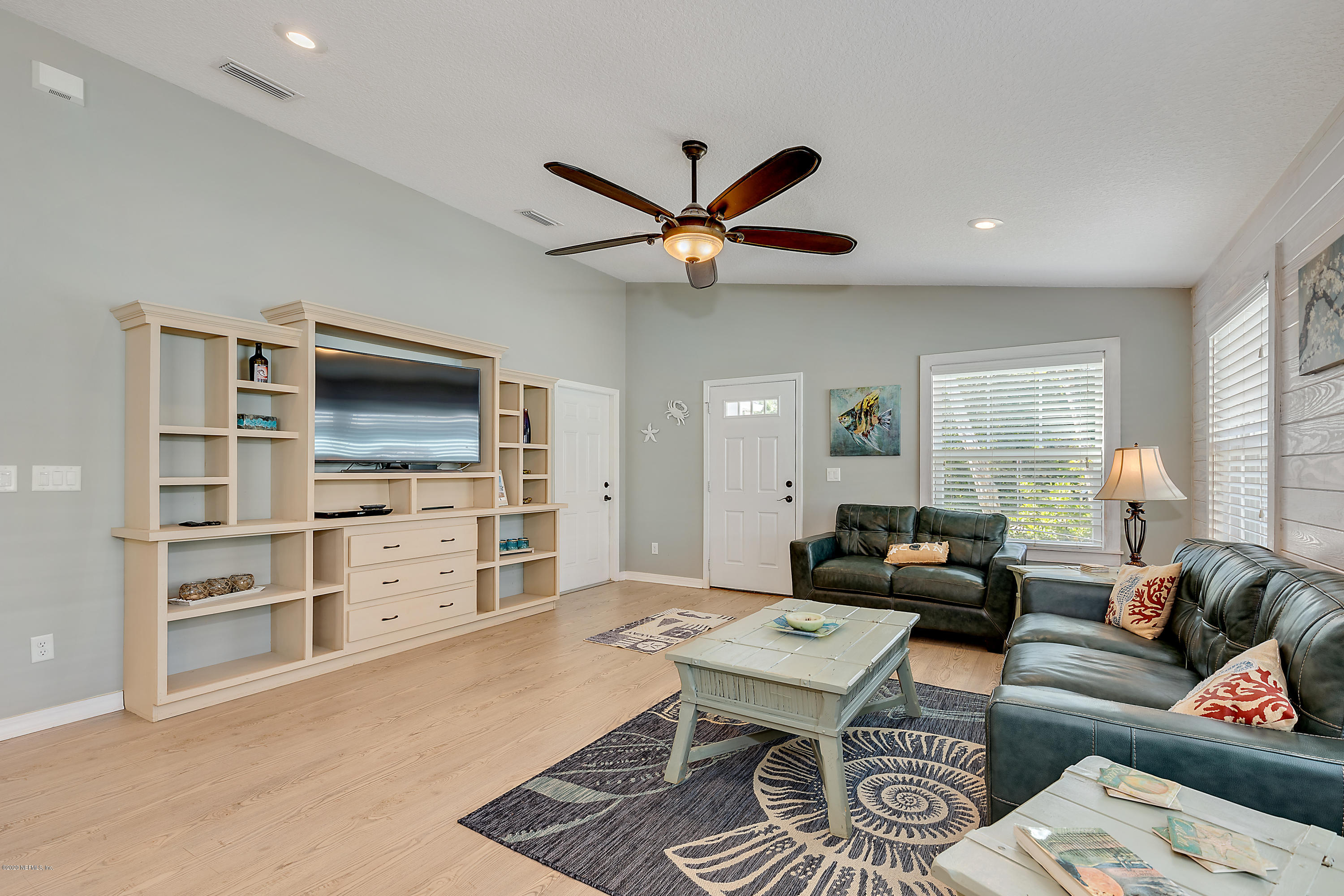 405 2nd Street St. Augustine, FL 32084 - Photo 7 of 32 a living room with furniture a flat screen tv and kitchen view
