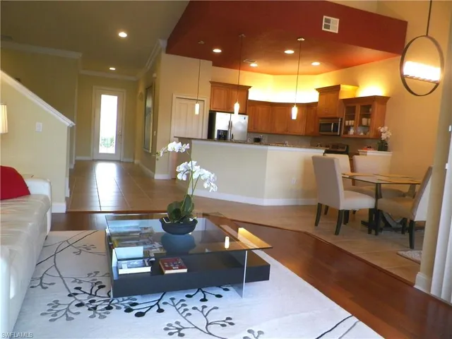 a living room with table and chairs
