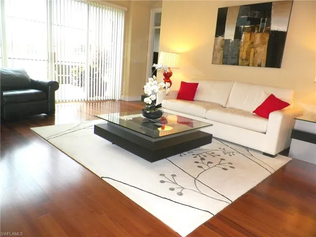 a living room with furniture and large windows