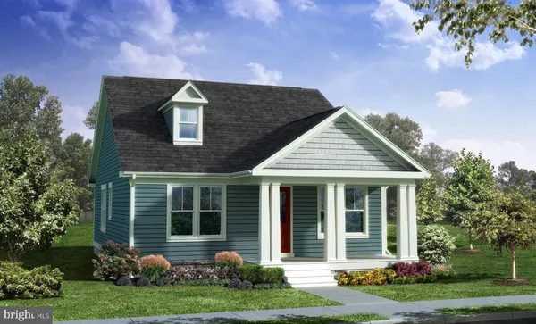 a front view of a house with a yard and potted plants