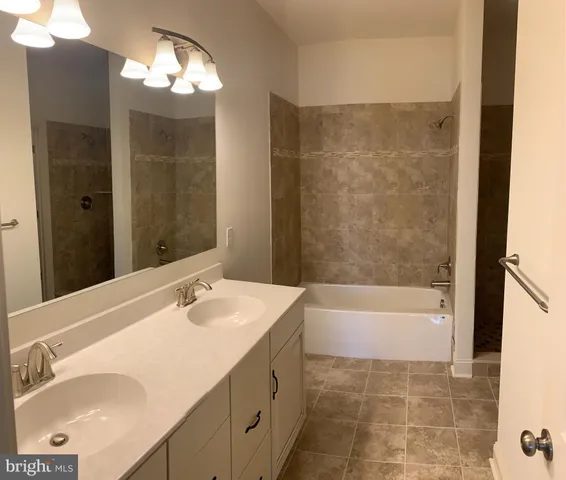 a bathroom with a bathtub and a sink