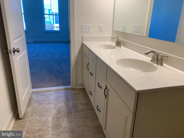 a view of a room with wooden floor and a window