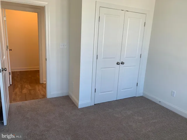 a kitchen with granite countertop a stove top oven a sink dishwasher and a refrigerator with wooden floor