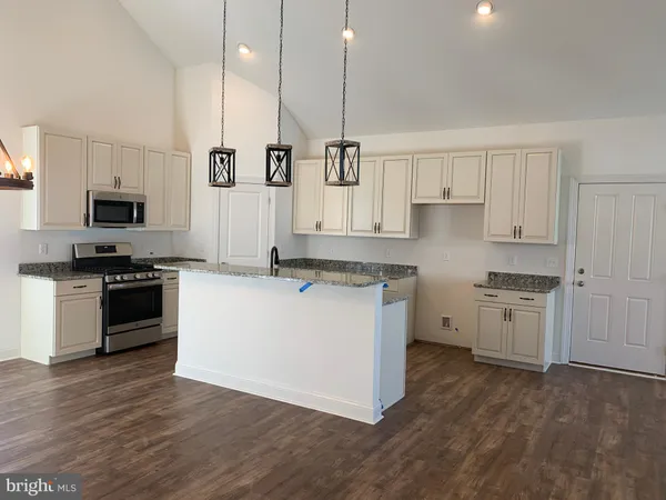 a kitchen with sink refrigerator and stove