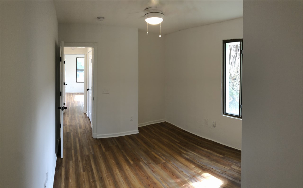 170 Twine Street St. Augustine, FL 32084 - Photo 13 of 24 an empty room with wooden floor and windows