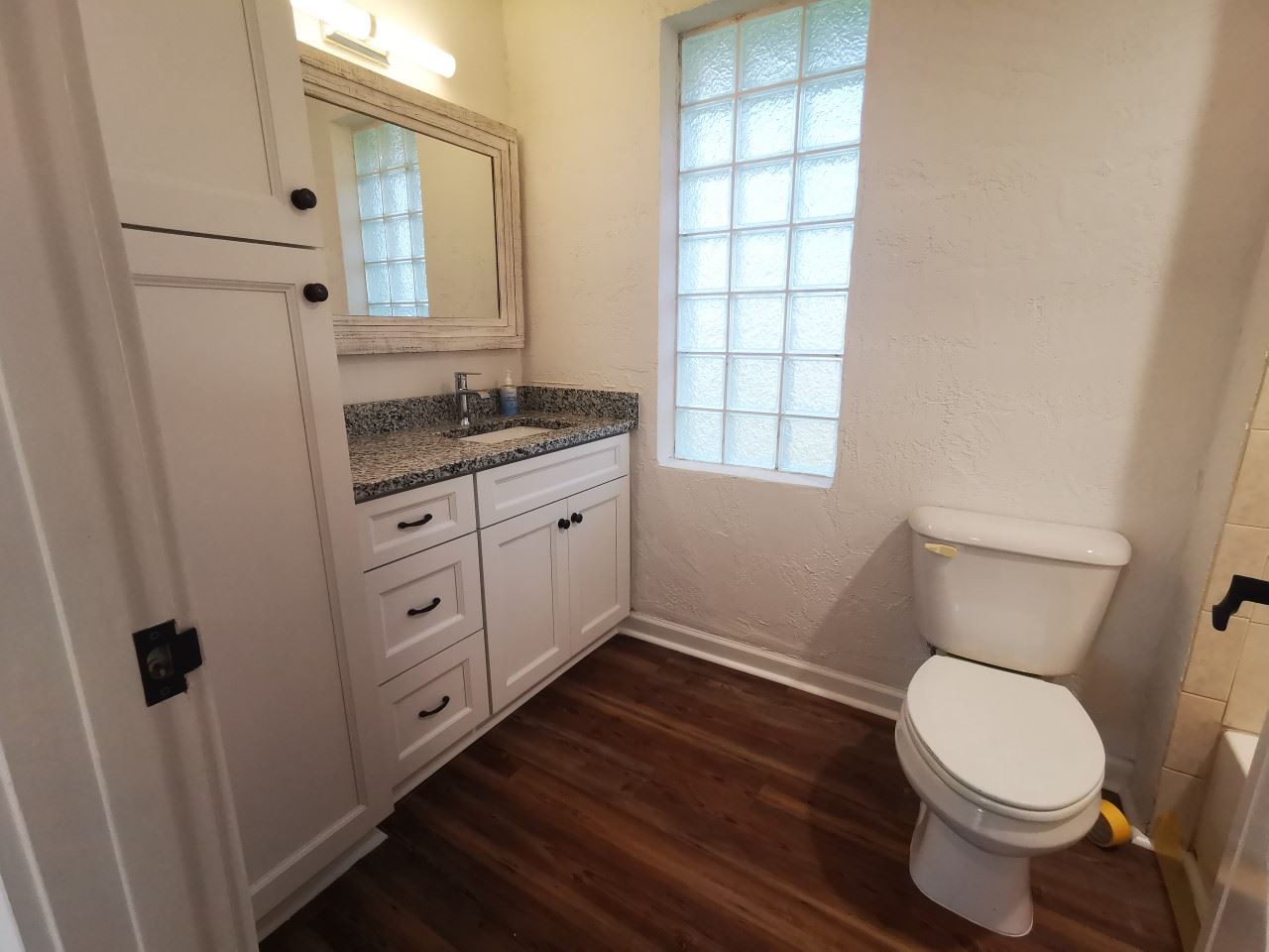 170 Twine Street St. Augustine, FL 32084 - Photo 18 of 24 a bathroom with a granite countertop toilet sink and mirror
