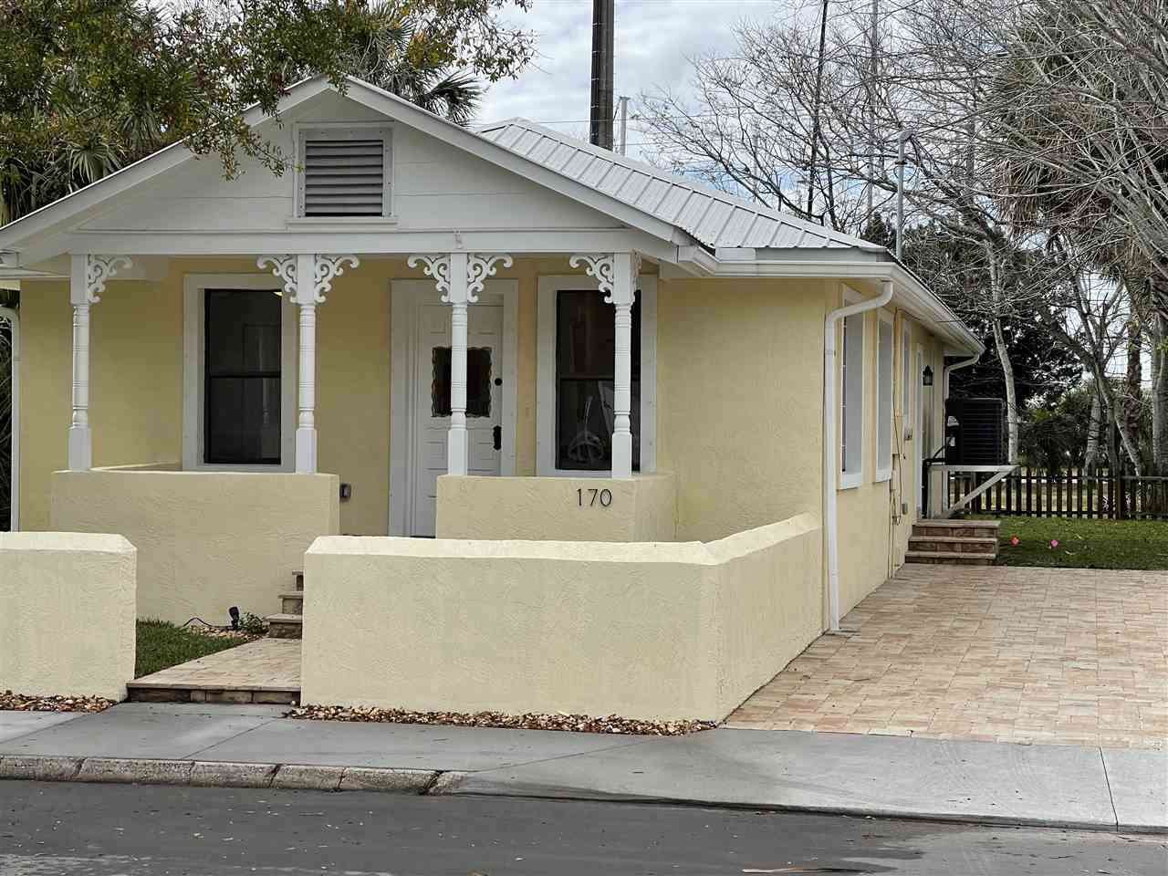170 Twine Street St. Augustine, FL 32084 - Photo 5 of 24 a view of a white house with a large tree and wooden fence