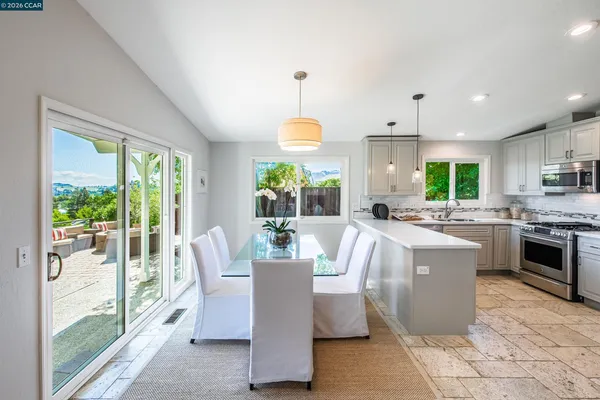 a living room with kitchen island furniture and a chandelier