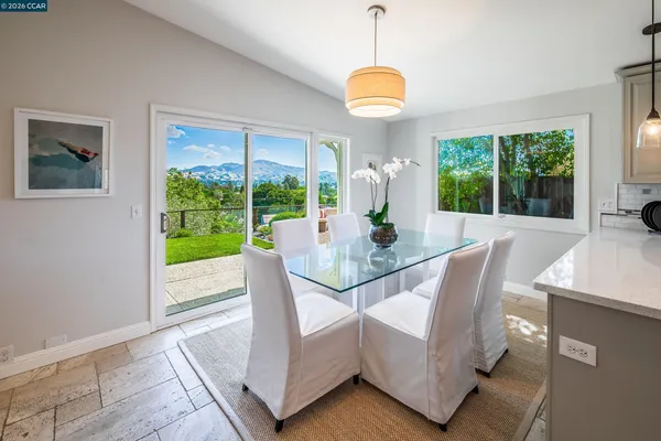 a view of a dining room with furniture window and outside view