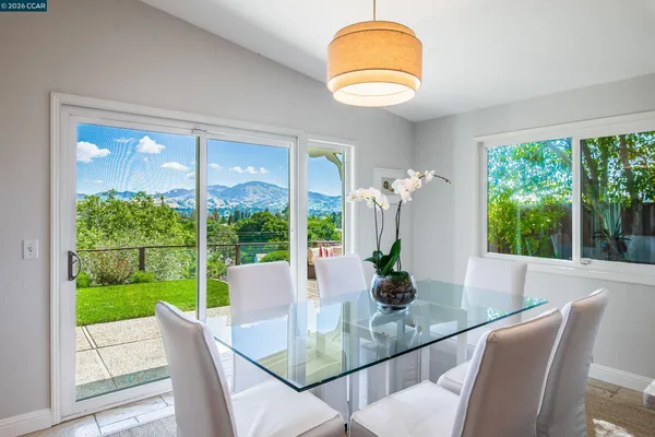 a view of a dining room with furniture window and outside view