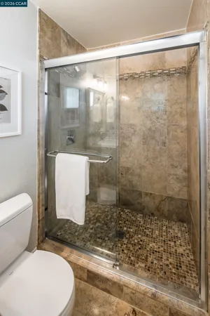 a bathroom with a toilet and a shower