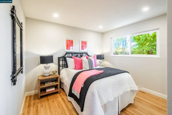 a bedroom with a bed and a large window